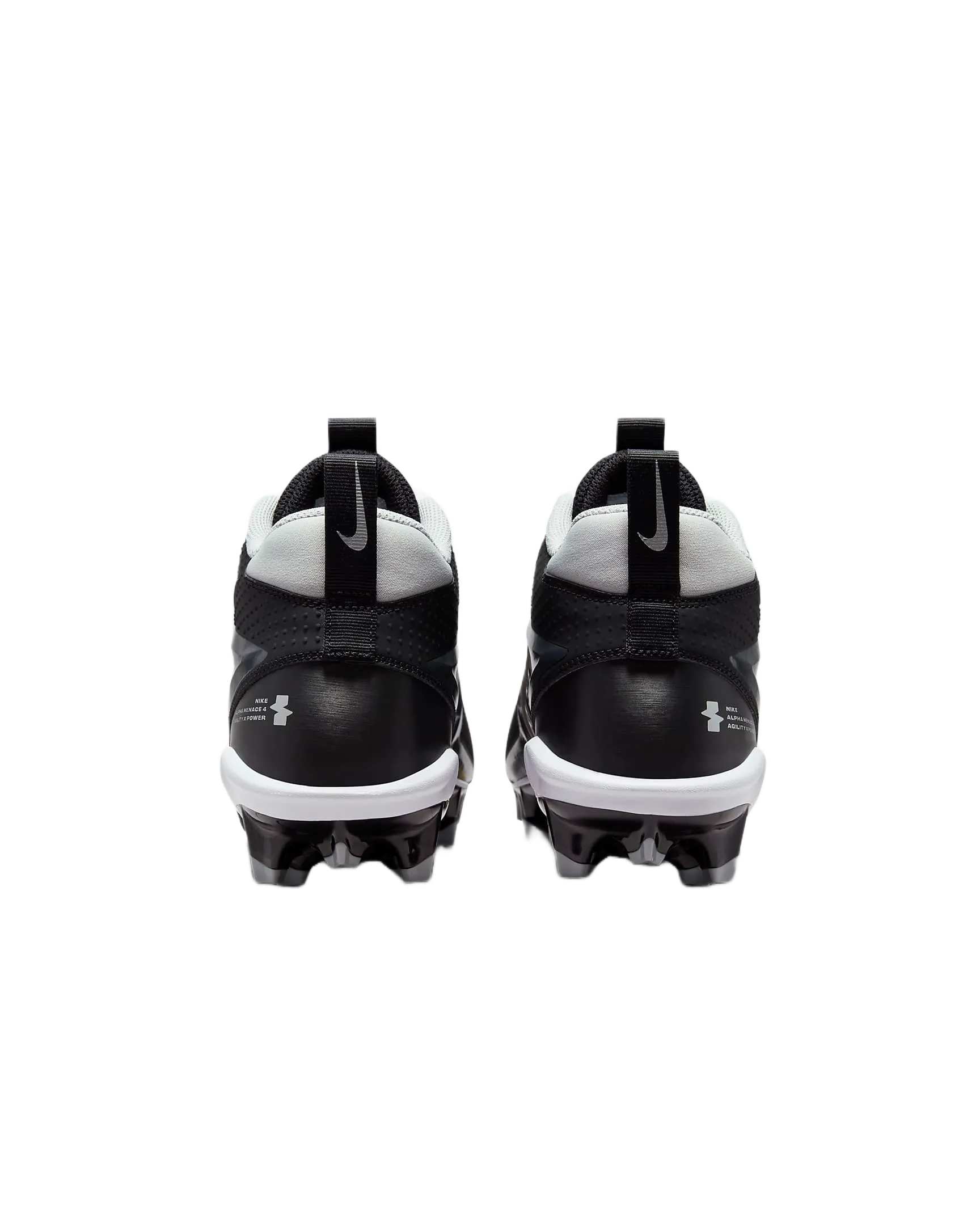 Rear view of black and white Nike Alpha Menace Varsity 4 cleats with cleated soles for football.