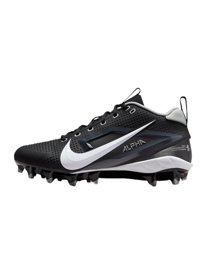 Black and white Nike Alpha Menace Varsity 4 cleats with large white swoosh and molded cleats for football.